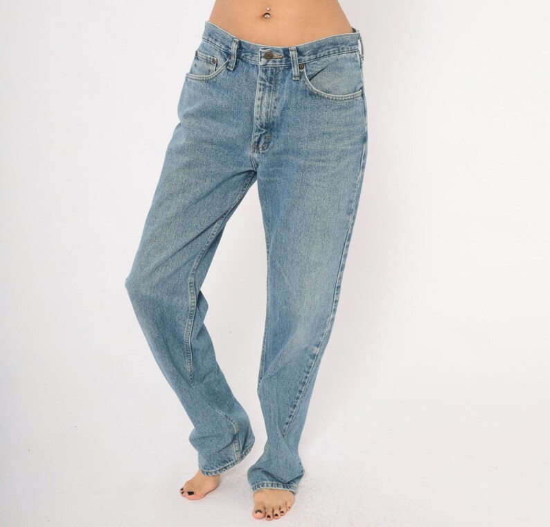 Peut inclure: Jean en denim bleu clair avec une conception classique &agrave; cinq poches. Le jean a une coupe droite et une fermeture &agrave; bouton et fermeture &eacute;clair. Le denim a un d&eacute;lavage d&eacute;color&eacute;, donnant au jean un aspect vintage.