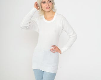 May include: White long-sleeved thermal shirt with a crew neck.