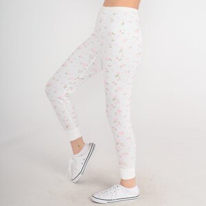 May include: White thermal underwear with a floral print. The underwear has a high waist and a fitted leg.