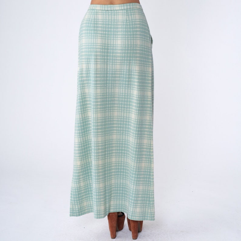 May include: A long, light blue skirt with a white plaid pattern. The skirt has a high waist and a straight silhouette.