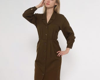 May include: Olive green button-down dress with long sleeves and a collared neckline. The dress features a fitted waist and a knee-length hemline. The dress has a classic, tailored design.