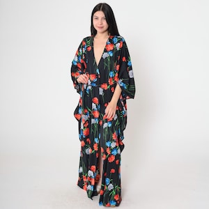 May include: A black maxi dress with a floral print featuring red, blue, and white flowers. The dress has a V-neckline and long sleeves.