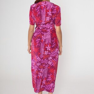 May include: A long, pink and red floral print wrap dress with a V-neckline and short sleeves.