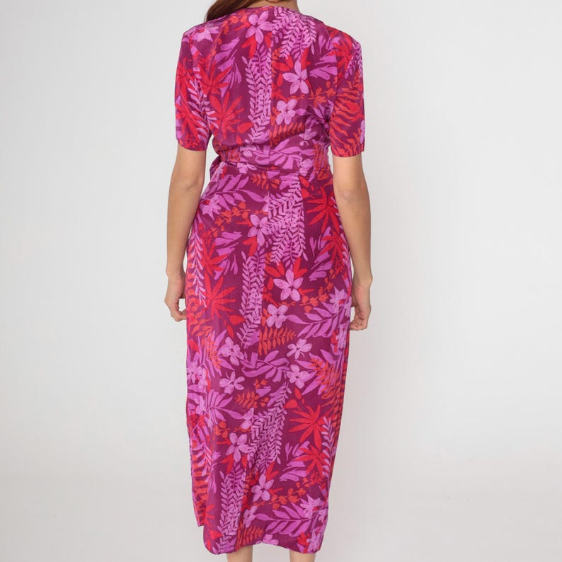May include: A long, pink and red floral print wrap dress with a V-neckline and short sleeves.