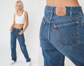 May include: A pair of blue denim jeans with a brown leather patch that says "Levi Strauss & Co.  Original  Quality  Clothing  XX".
