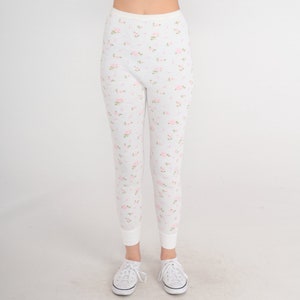 May include: White thermal underwear leggings with a pink floral pattern.