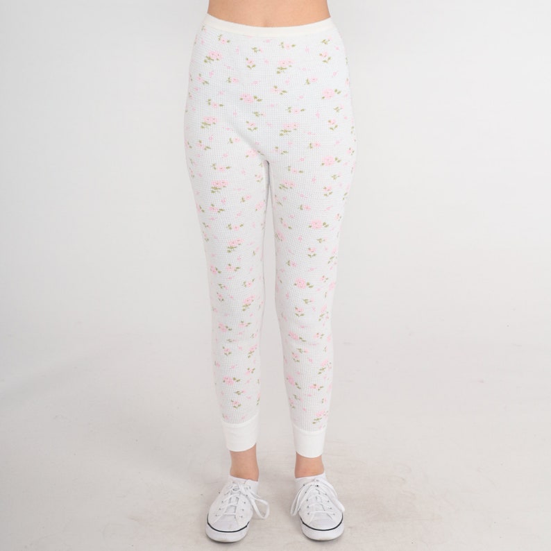 May include: White thermal underwear leggings with a pink floral pattern.