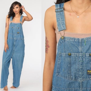 May include: A pair of blue denim dungarees with adjustable straps and a brand label that reads "OshKosh B'Gosh".