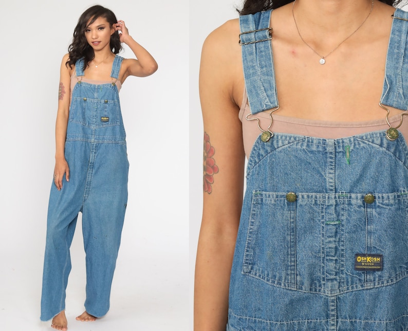 May include: A pair of blue denim dungarees with adjustable straps and a brand label that reads "OshKosh B'Gosh".