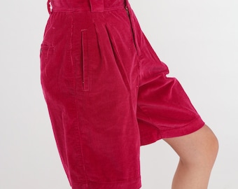 May include: Pink corduroy shorts with pleats and a side pocket.