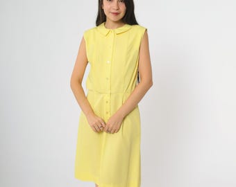 May include: A sleeveless, yellow dress with a rounded collar and button-down front. The dress features vertical pleats on the bodice and a fitted waist. The skirt falls to the knees. The model is wearing the dress.