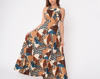 May include: A long, flowing maxi dress with a geometric pattern in shades of brown, blue, and white. The dress has a halter neckline and a fitted bodice.