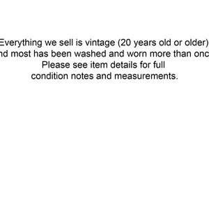 May include: Text stating that all items sold are vintage, at least 20 years old, and have been washed and worn. It also encourages buyers to check item details for condition notes and measurements.