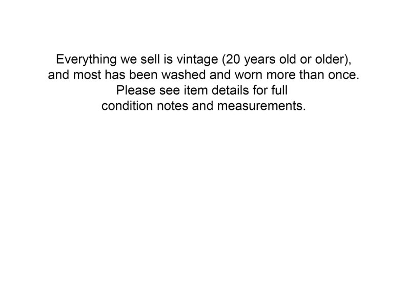 May include: Text stating that all items sold are vintage, at least 20 years old, and have been washed and worn. It also encourages buyers to check item details for condition notes and measurements.