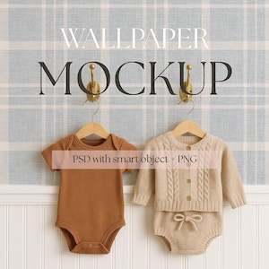 May include: A mockup featuring baby clothing on hangers against a plaid wallpaper backdrop. The image includes a brown onesie and a beige knit sweater set. Text on the image reads "WALLPAPER MOCKUP" and "PSD with smart object + PNG".