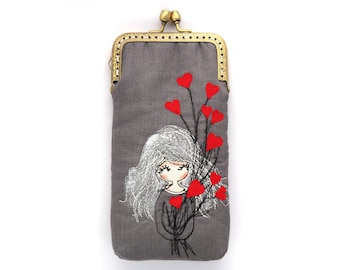 May include: A gray linen coin purse with a brass clasp and an embroidered design of a girl with gray hair holding a bouquet of red hearts.