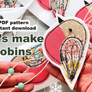 May include: Handmade robin decorations with red, beige, and patterned fabric. The ornaments have white backing and black stitched outlines. Text reads "Let's make Robins" and "PDF pattern instant download".