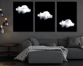 May include: Three-panel wall art featuring white cloud designs against a black background. The artwork is displayed above a gray sofa with a matching ottoman and throw blanket. The room has dark gray walls and hanging pendant lights.