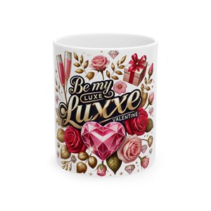 May include: White ceramic mug with a Valentine's Day design. The mug features the text "Be my Luxe Valentine" in gold and black script, along with a pink gem heart, roses, and gift box illustrations.