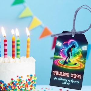 May include: A black and white thank you tag with a neon green, blue, and purple golf player graphic. The text on the tag reads "Thank You! for celebrating my big swing with me!"