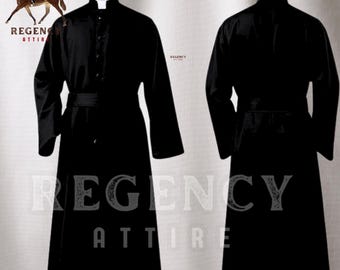 May include: A black cassock with a clerical collar and a black sash. The cassock is a long, flowing garment worn by clergy.