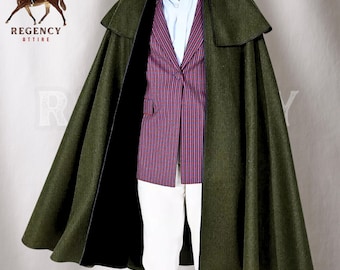 May include: A dark green wool cape with a black lining and a high collar. The cape has a long, flowing design and is worn over a patterned blazer and white pants.