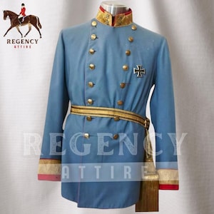 May include: A blue military uniform with gold trim and buttons. The uniform has a high collar with a red and gold trim. A gold belt with a gold buckle is worn around the waist. A gold tassel hangs from the belt. The uniform has a black iron cross on the left chest. The text "REGENCY ATTIRE" is visible on the image.
