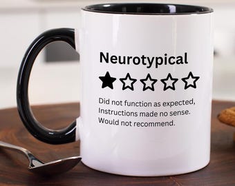 May include: White coffee mug with a black rim and handle. The mug features a black and white graphic that says "Neurotypical" with a one-star rating and the text "Did not function as expected, Instructions made no sense. Would not recommend."