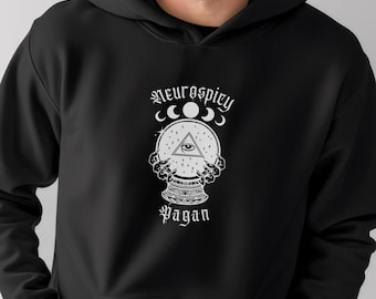 May include: Black hooded sweatshirt with a white graphic design of a crystal ball with an all-seeing eye and the text "Neurospicy Pagan".