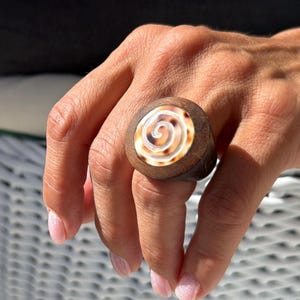 Anello in conchiglia intagliato nel legno