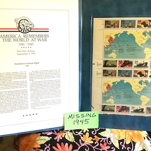 May include: A blue binder with a white page showing text about "America Remembers the World at War" and a stamp collection with a world map and stamps from 1941. A green sticky note says "Missing 1945".