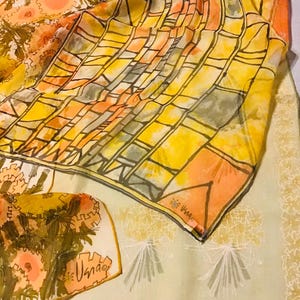 May include: A collection of vintage silk scarves in shades of yellow, orange, and brown. One scarf features a geometric pattern with black outlines, while another displays floral designs. The scarves are lightweight and appear to be made of delicate silk.