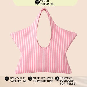 May include: A star-shaped bag featuring a pink and white vertical striped pattern. The text reads: STAR BAG PATTERN, VIDEO TUTORIAL, PRINTABLE PATTERN A4, STEP BY STEP INSTRUCTIONS, INSTANT DOWNLOAD PDF FILES. The bag has a central opening for handles.