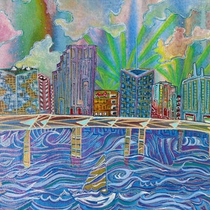 May include: A colorful painting of a city skyline with buildings reflected in a blue and purple river. The sky is a mix of pink, green, and yellow with clouds.
