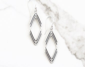 Geometric dangle silver earrings in an arrowhead shape handmade of individually formed pieces of silver wire - "Arrowhead Earrings"