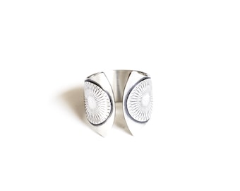 Wide band silver ring with a sun solar motif and a dual fluted shape with twin patterned circles at the curved open ends - "Helios Ring"