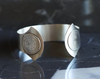 Sterling silver cuff bracelet with a sun solar motif and a dual fluted shape with twin patterned circles at curved open ends - "Helios Cuff"