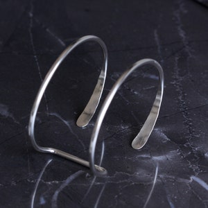 Modern silver cuff bracelet handmade of sturdy 10 gauge sterling silver wire formed into a sleek prong shape Large Hammered Tail Cuff image 4