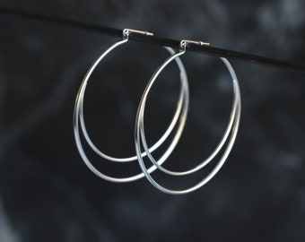 Silver hoops unique design embellished with a sterling silver half arc enclosed in the interior of the sterling hoop - "Meridian Earrings"