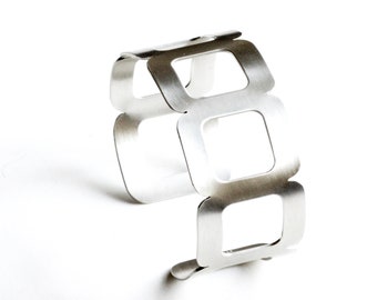 Modern silver bracelet cuff, handmade sterling silver cuff of 7 cushion shapes, a striking and edgy design - "Seven Stars Cuff"