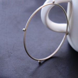 Modern silver bangle bracelet formed and forged of thick silver wire and accented with silver balls, perfect for stacking - "Compass Bangle"