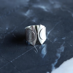 Wide band silver ring with a sun solar motif and a dual fluted shape with twin patterned circles at the curved open ends - "Helios Ring"