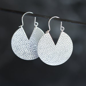 Bold silver earrings, eye-catching design of textured silver discs with cut-out V shapes for added contrast - "Iya Earrings - Small"