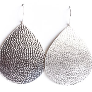 Large and eye-catching sterling silver earrings with a hammered bubble texture on a sleek teardrop shape - "Large Juno Earrings - Silver"