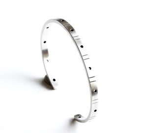 Modern sterling silver cuff bracelet with a repeating chiseled line and drilled hole pattern, perfect thin cuff for stacking - "Reverb Cuff"