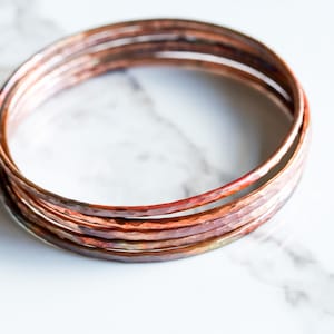 Set of five hammered copper bracelets formed and heat treated for a unique modern look and splash of fall colors - "Desert Bangles - Copper" image 1