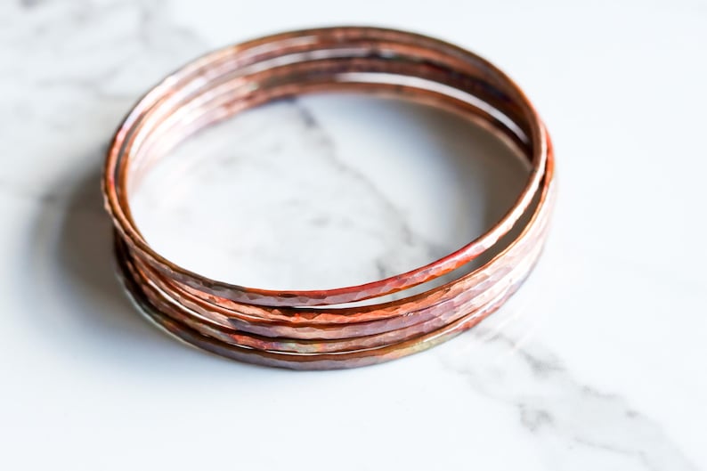 Set of five hammered copper bracelets formed and heat treated for a unique modern look and splash of fall colors - "Desert Bangles - Copper" image 1