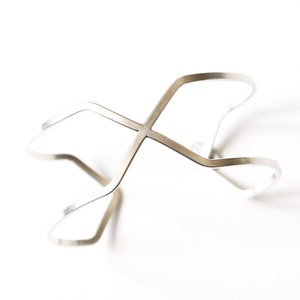Distinctive geometric wire bracelet handformed using sturdy flattened 12 ga silver wire into a striking minimalist design - "Crossings Cuff"