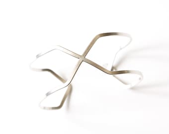 Distinctive geometric wire bracelet handformed using sturdy flattened 12 ga silver wire into a striking minimalist design - "Crossings Cuff"