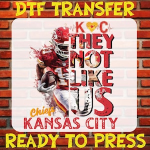 May include: Red, white, and yellow graphic design with a football player wearing a red and white jersey. The text reads "KCC They Not Like Us Chiefs Kansas City Ready To Press".